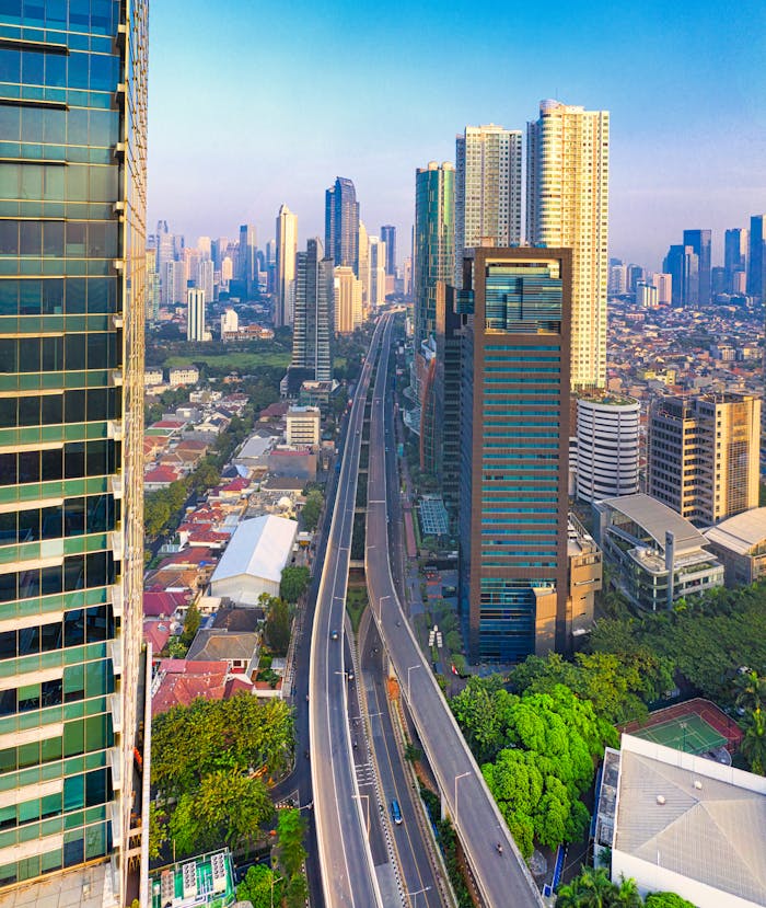 Stunning aerial panorama of a bustling modern cityscape with skyscrapers and infrastructure.